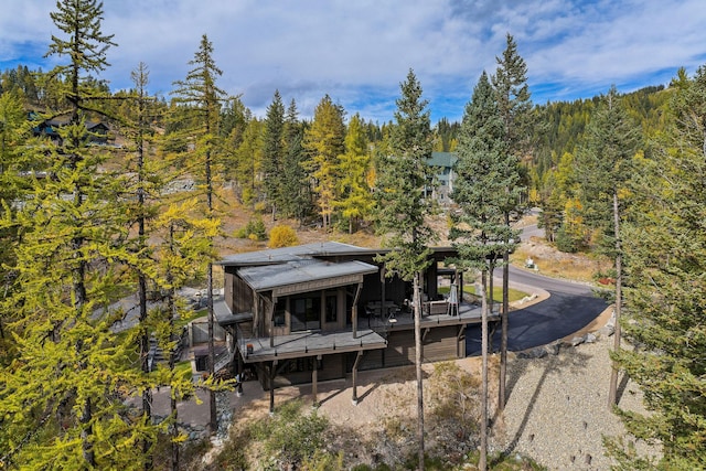 back of property featuring covered porch