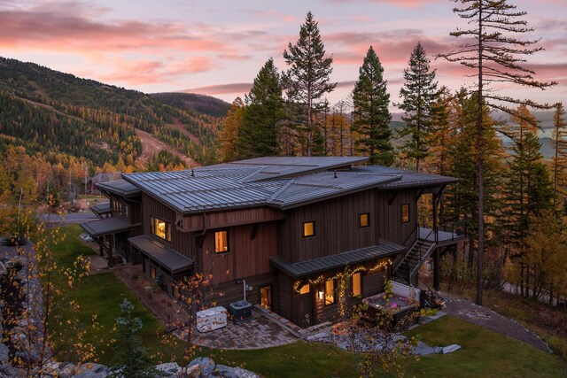 back house at dusk with a wooden deck