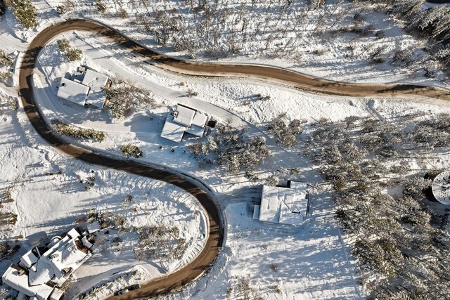 snowy aerial view with a mountain view