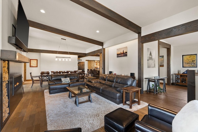 living room with beam ceiling and dark hardwood / wood-style flooring