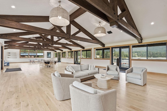 living room with beamed ceiling, light hardwood / wood-style floors, and high vaulted ceiling