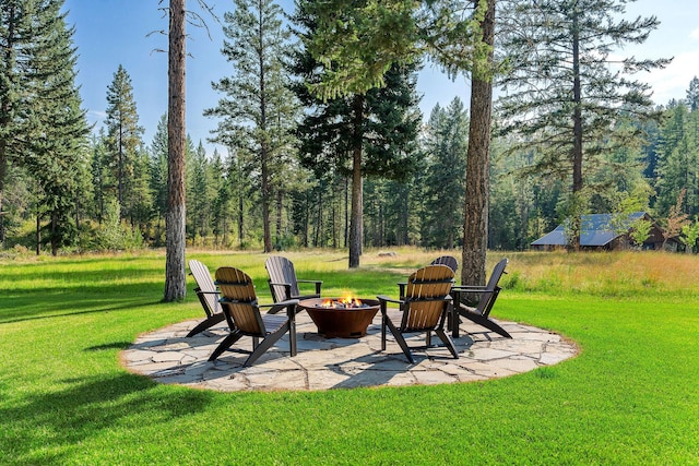 view of yard featuring a fire pit and a patio