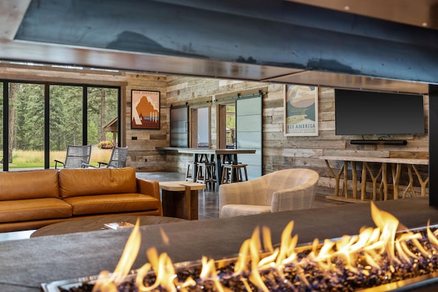 interior space with wood walls and a barn door