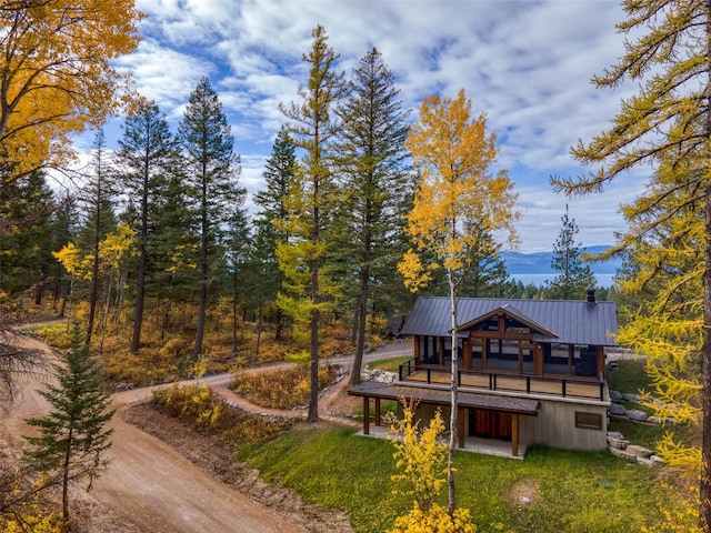 rear view of property featuring a deck with mountain view