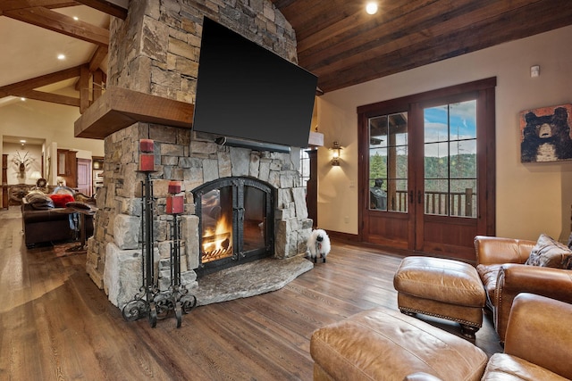 living room featuring wood-type flooring, beam ceiling, high vaulted ceiling, and a stone fireplace