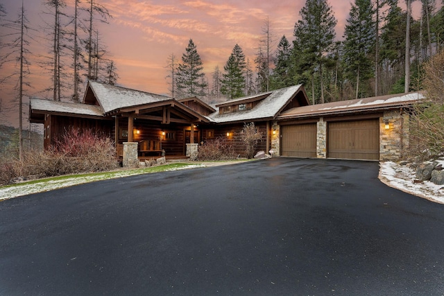 view of front of property with a porch and a garage