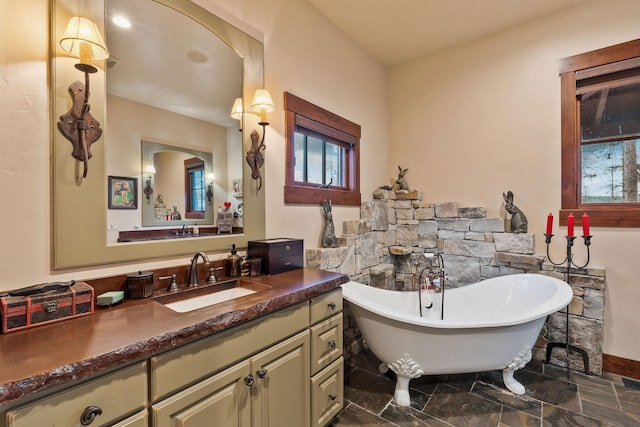 bathroom featuring a washtub and vanity