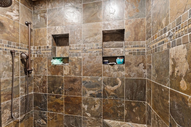 bathroom with tiled shower