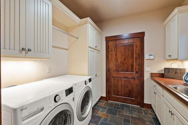 washroom featuring sink, cabinets, and washer and dryer