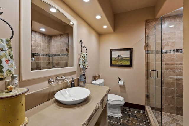 bathroom featuring vanity, toilet, and walk in shower