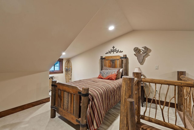 carpeted bedroom with lofted ceiling