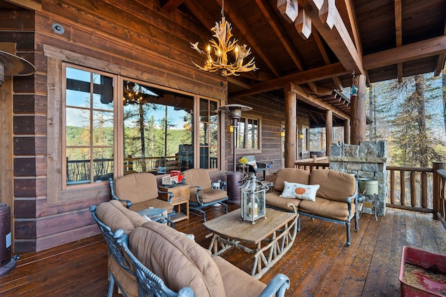 exterior space with wood ceiling, a healthy amount of sunlight, a notable chandelier, and vaulted ceiling with beams