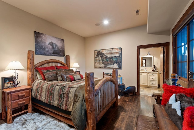 bedroom featuring sink, hardwood / wood-style floors, and ensuite bathroom