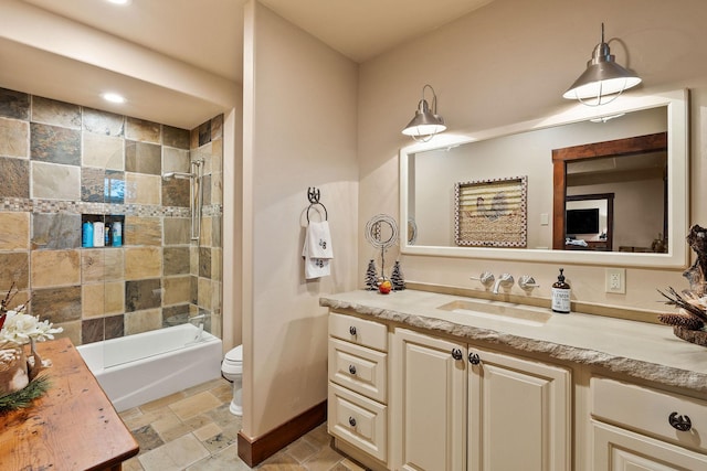 full bathroom featuring vanity, toilet, and tiled shower / bath