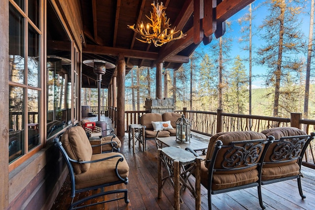 sunroom / solarium featuring wooden ceiling, an inviting chandelier, and beamed ceiling