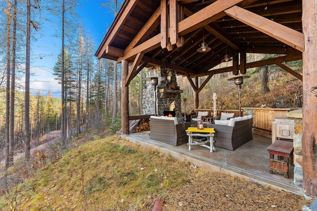 view of yard with a gazebo, a patio area, and an outdoor living space with a fireplace