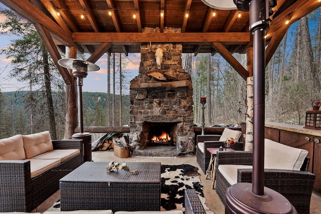 patio terrace at dusk with an outdoor living space with a fireplace