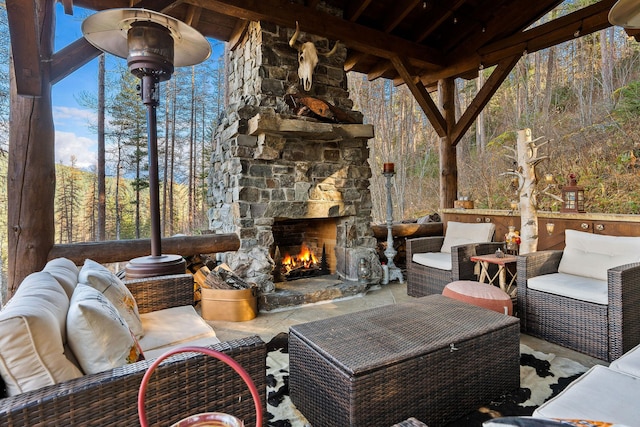 view of patio with an outdoor living space with a fireplace