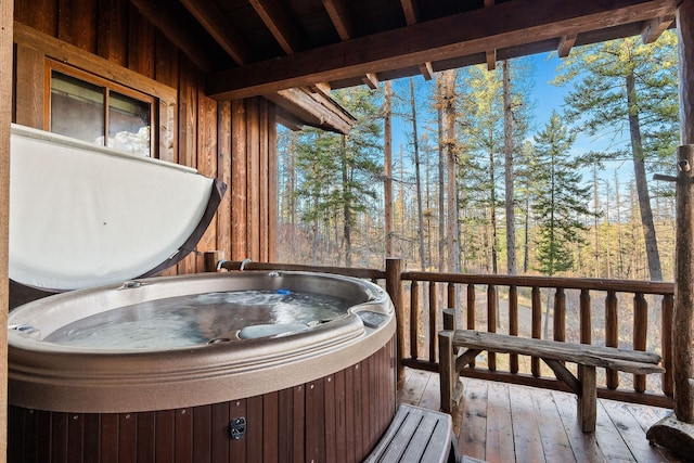 wooden deck featuring a hot tub