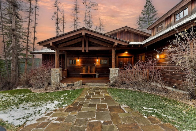 exterior entry at dusk with covered porch