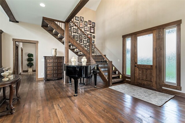 living room with high vaulted ceiling, dark hardwood / wood-style floors, a stone fireplace, and beamed ceiling