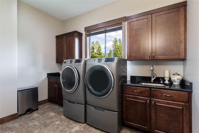 washroom with cabinets, sink, and independent washer and dryer