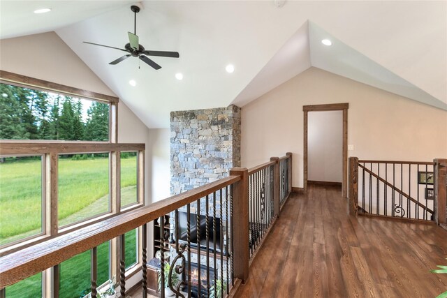 hallway with a chandelier, dark wood-type flooring, and lofted ceiling