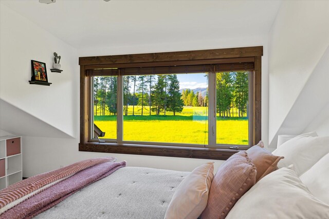 bedroom featuring ceiling fan and lofted ceiling