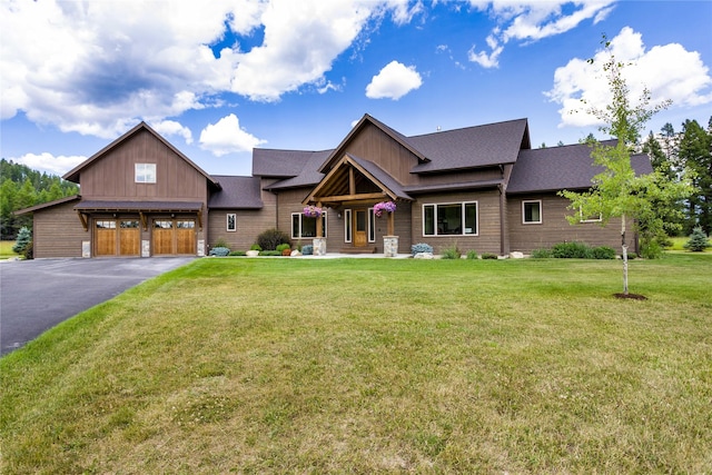 view of front of house with a garage, a front lawn, and covered porch