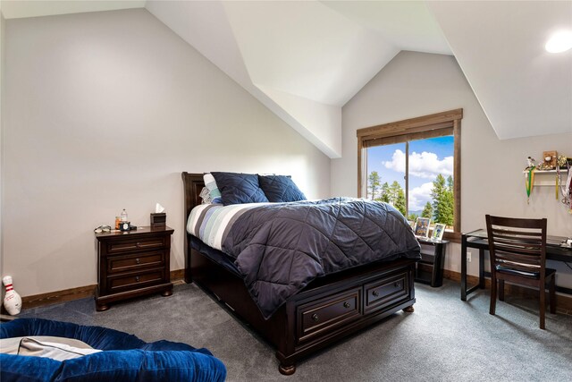 bathroom with toilet, walk in shower, vanity, and vaulted ceiling