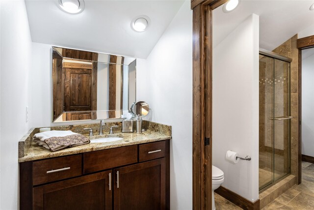 bathroom with vaulted ceiling, an enclosed shower, and vanity