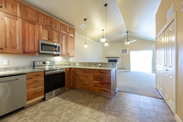 kitchen with appliances with stainless steel finishes, decorative light fixtures, vaulted ceiling, ceiling fan, and light colored carpet