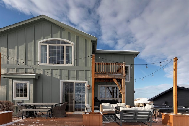 rear view of house featuring a deck and an outdoor hangout area