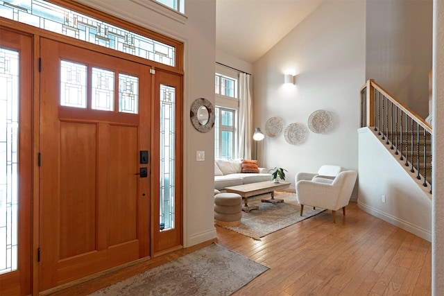 entryway featuring high vaulted ceiling and light wood-type flooring