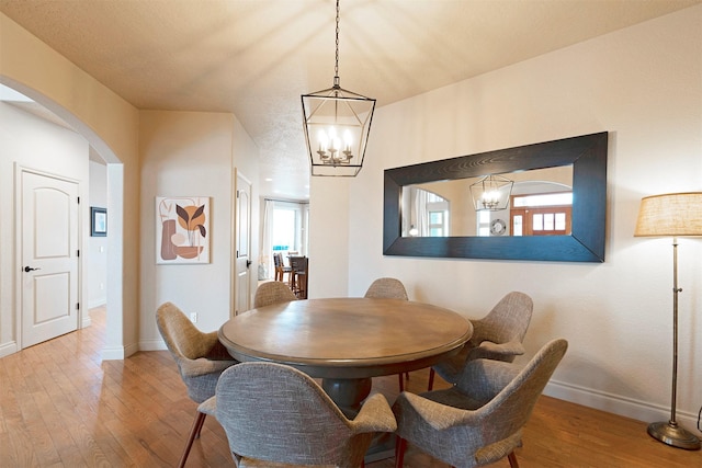 dining room featuring a chandelier and light hardwood / wood-style flooring