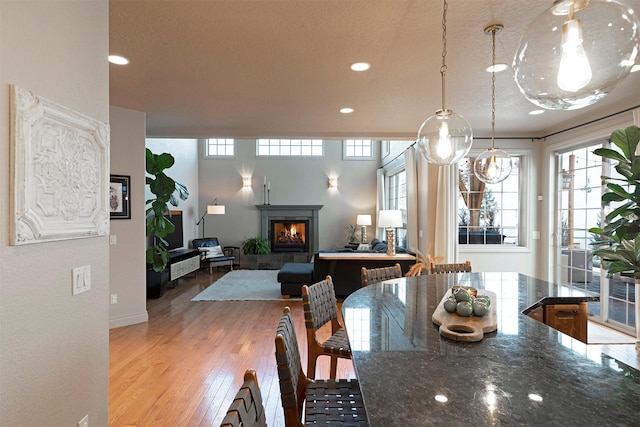 dining room featuring a fireplace and light hardwood / wood-style flooring