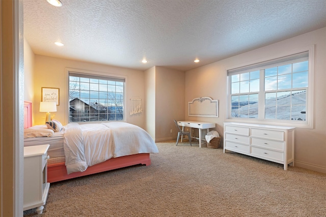 carpeted bedroom with a textured ceiling