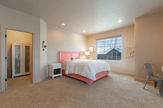 carpeted bedroom featuring a textured ceiling