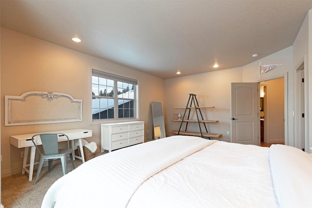 bedroom with a textured ceiling and carpet floors