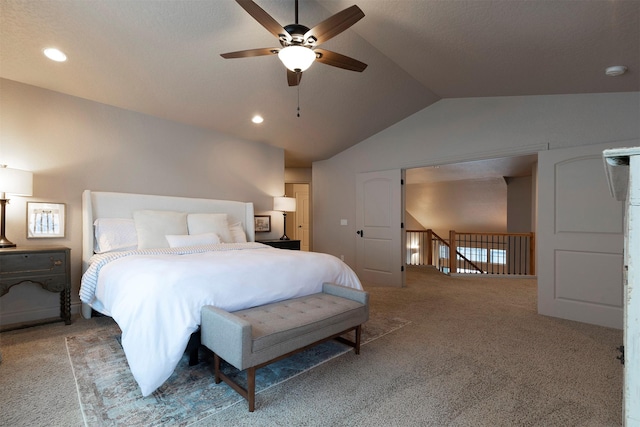 carpeted bedroom featuring ceiling fan and vaulted ceiling