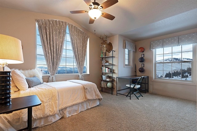 carpeted bedroom featuring lofted ceiling and ceiling fan