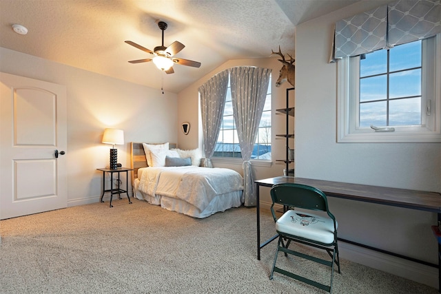 carpeted bedroom featuring ceiling fan, a textured ceiling, and lofted ceiling