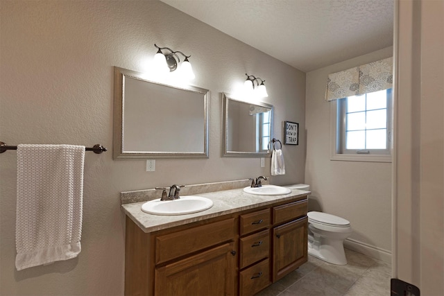 bathroom with vanity, toilet, and tile patterned flooring