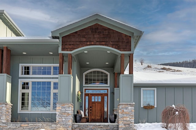 view of snow covered property entrance