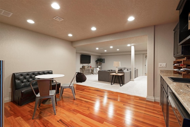 dining space featuring sink and light wood-type flooring