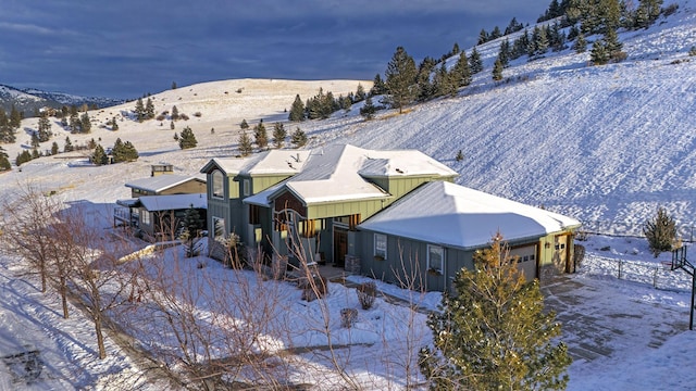 snowy aerial view with a mountain view