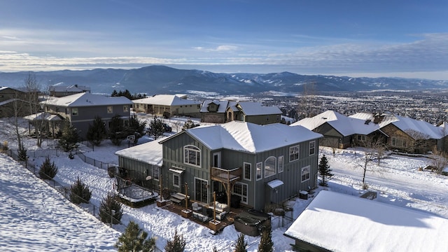 snowy aerial view featuring a mountain view