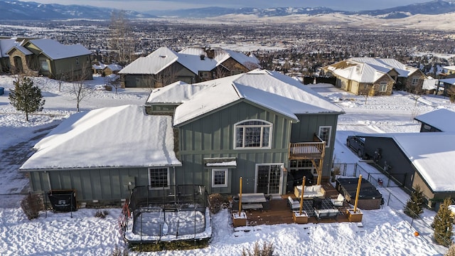 snowy aerial view featuring a mountain view