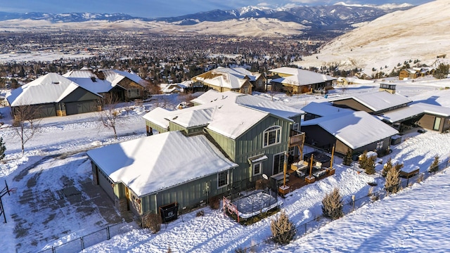 snowy aerial view featuring a mountain view