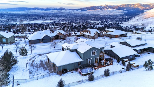 snowy aerial view featuring a mountain view